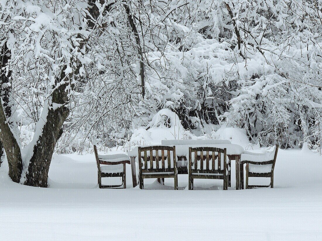 Snow covers an outside table and makes socializing impossible in winter, Pennsylvania, USA.