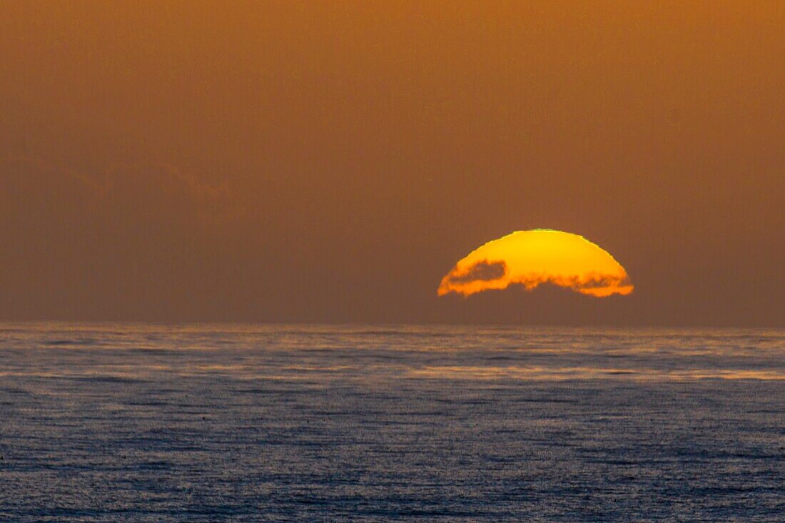 The sun sets on California's Pacific Ocean at San Simeon.
