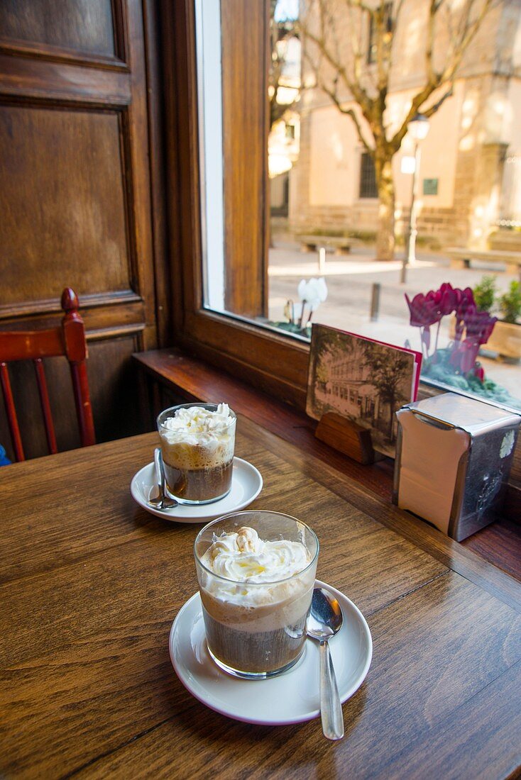 Two Irish coffees in a traditional cafe. San Lorenzo del Escorial, Madrid province, Spain.