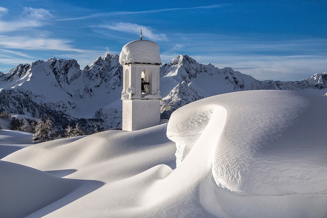 Bell tower and mountain hut submerged by snow Scima Alp Chiavenna Valley Valtellina Lombardy Italy Europe.