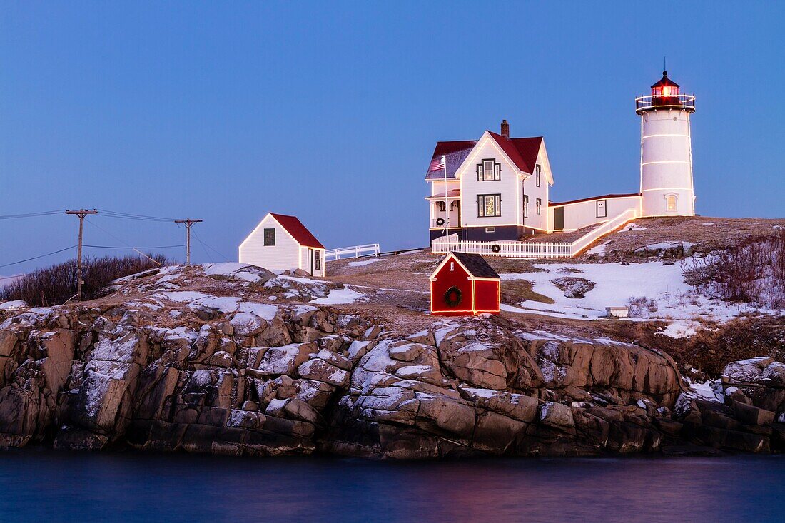 Twilight falls over Cape Neddick Lighthouse also known as Nubble Light in York, Maine.