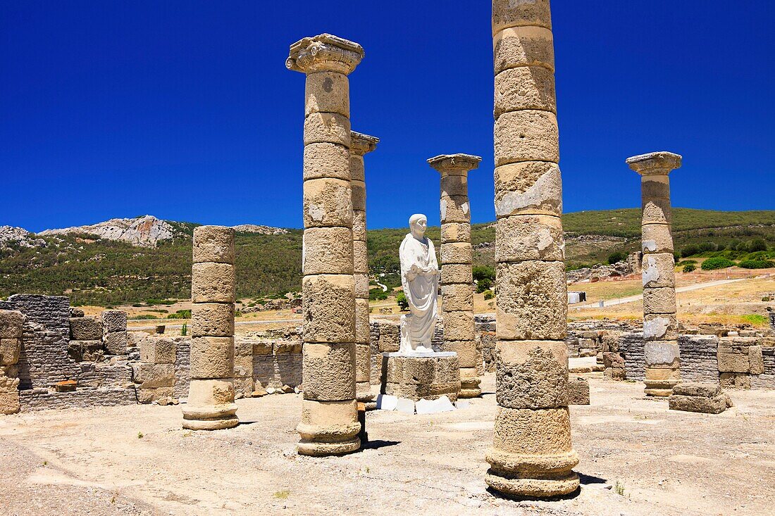 Trajan statue and Basilica at the Roman ruins of Baelo Claudia in Bolonia beach , Tarifa , Cadiz , Andalusia , Spain.
