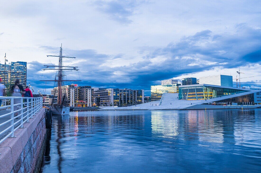 Oslo Opera Hall and sailboat at dusk, Norway.