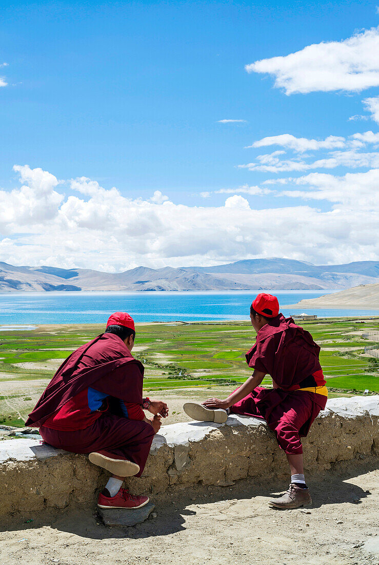 Buddhist young monks watching the views. Nomad summer festival in Tso Moriri lake, Ladakh (India).