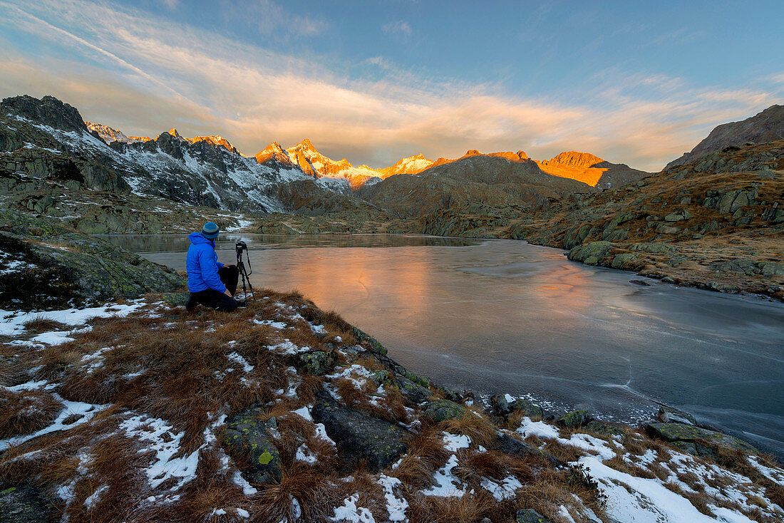 Italy, Trentino Alto Adige, Adamello Brenta Park, Nambrone valley, mountain photographer at work during a dawn at Black Lake.