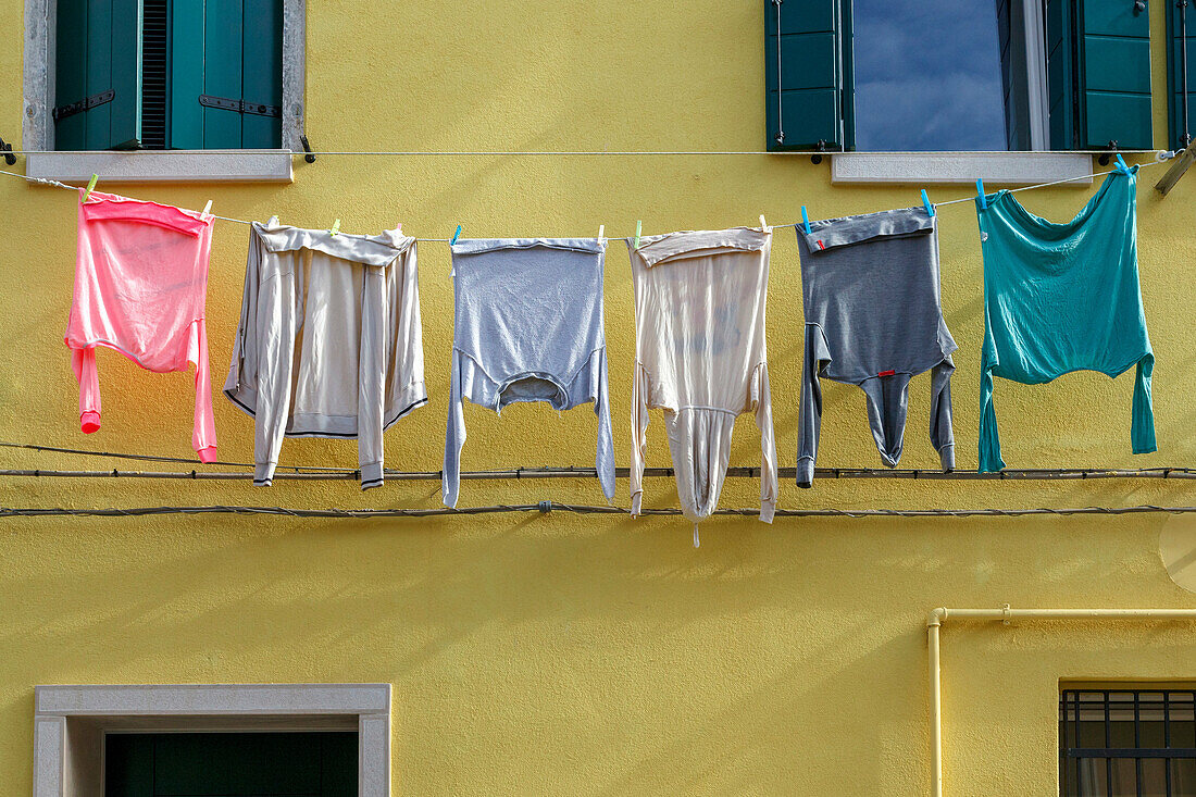 Europe, Italy, Veneto, Chioggia. Hanging clothes on a old house facade.