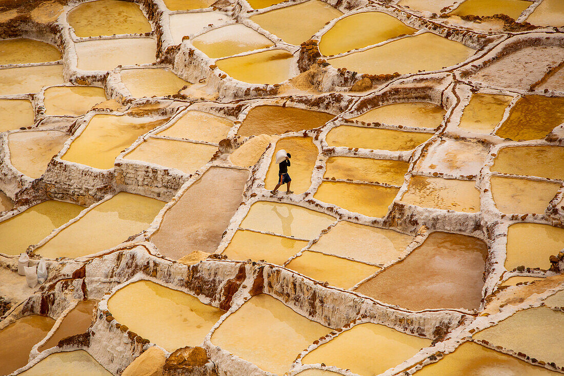 Worker mining for salt, Salineras de Maras, Maras Salt Flats, Sacred Valley, Peru, South America