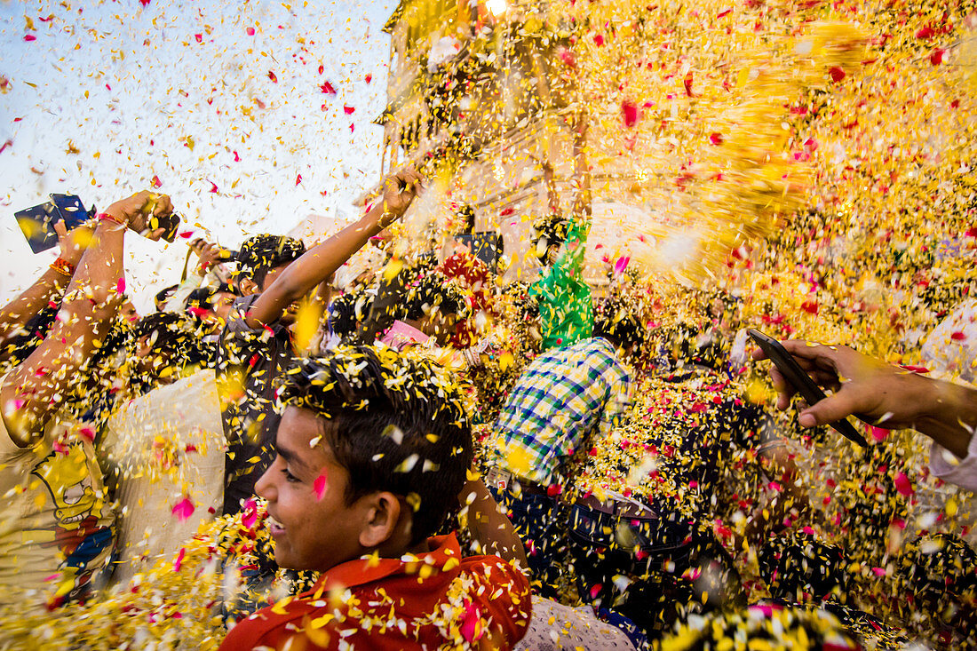 Crowd throwing flower petals during the Flower Holi Festival, Vrindavan, Uttar Pradesh, India, Asia