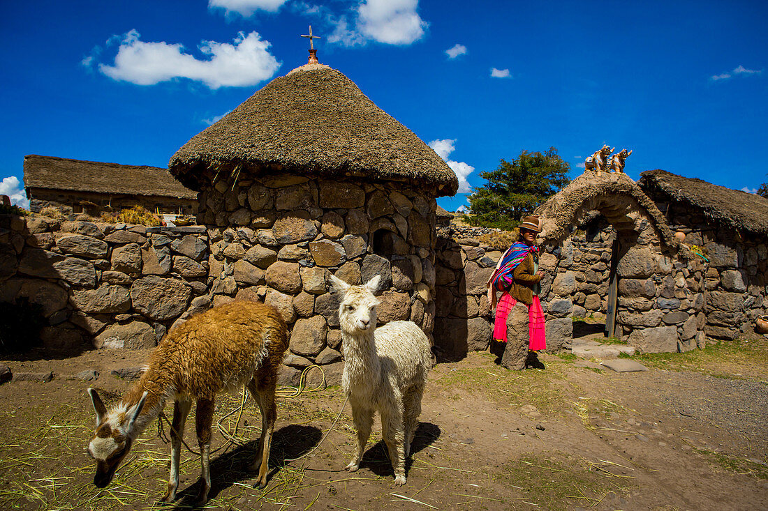 Woman standing at her home in Llacon, Lake Titicaca, Peru, South America