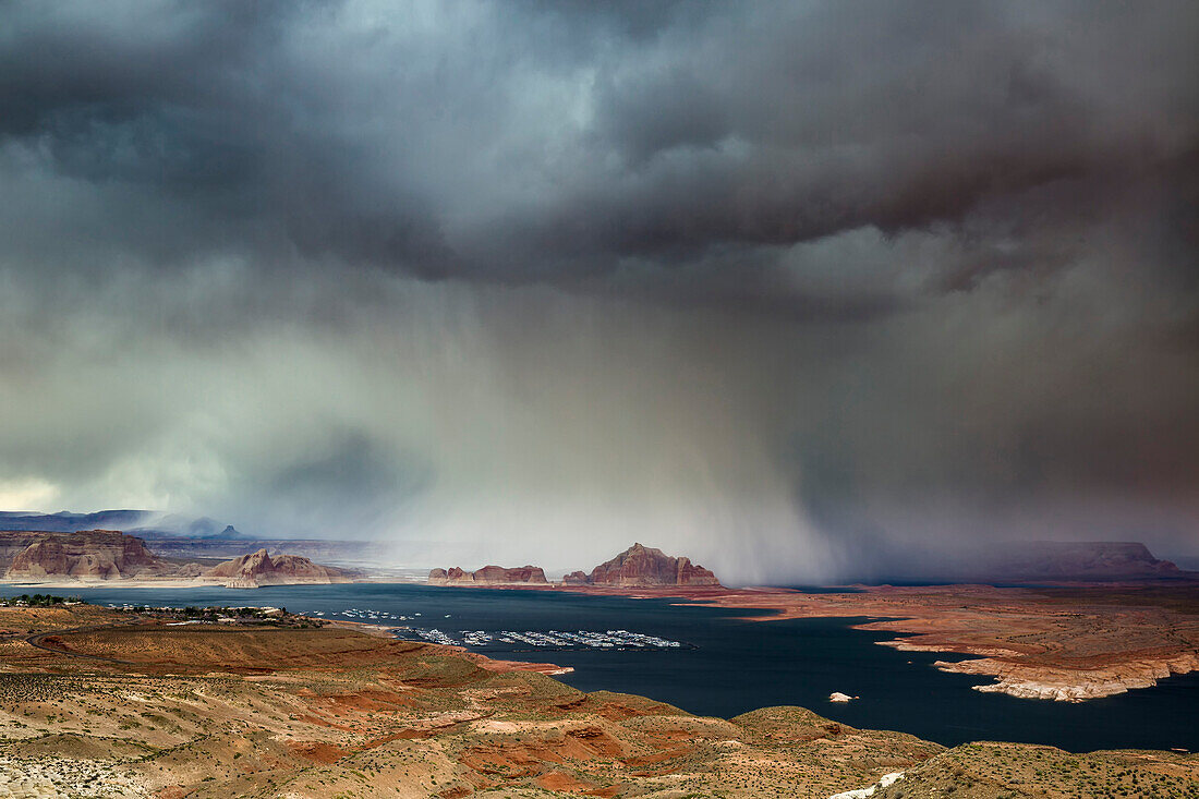 A storm obscures Grand Staircase-Escalante National Monument as it sweeps across Lake Powell and Wahweap Bay, Page, Arizona, United States of America, North America