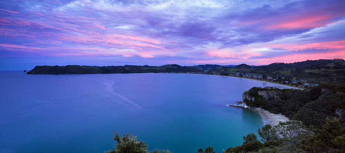 Dusk falls above Cooks Bay on the Pacific Ocean coast of the Coromandel Peninsula, North Island, New Zealand, Pacific