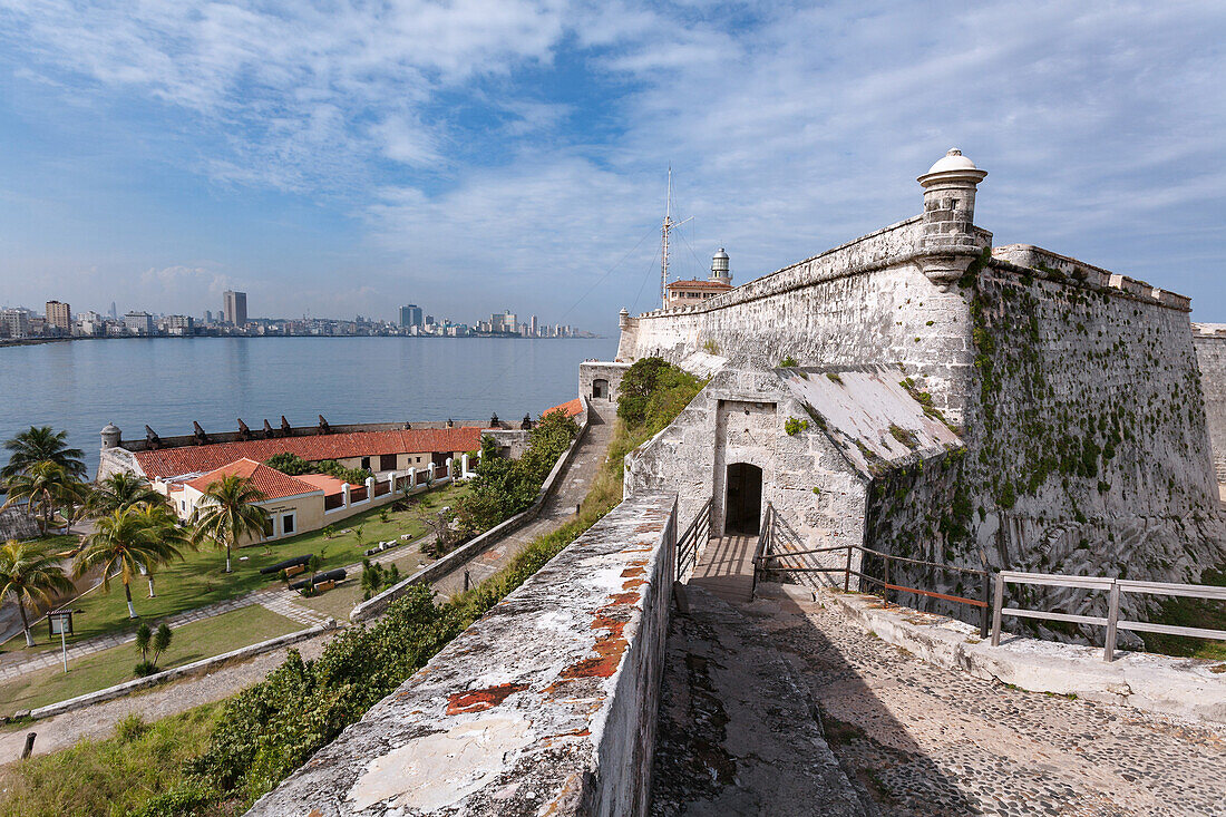 Looking across the calm waters of Havana Bay to Havana with the 16th century fortress, Morro Castle, standing guard, Havana, Cuba, West Indies, Caribbean, Central America