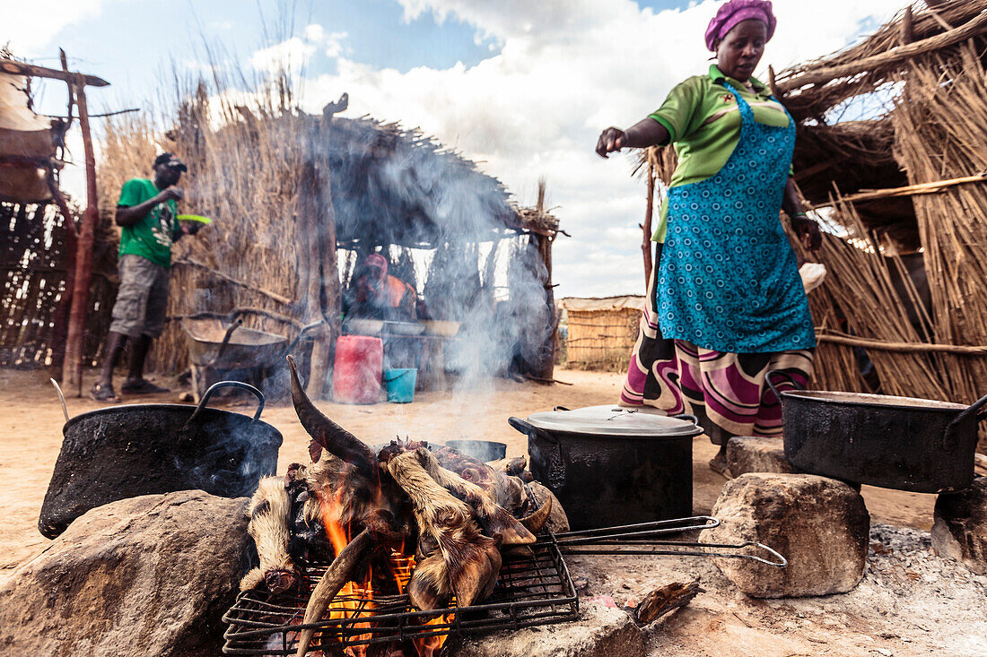 Ziegenfüße und -kopf über offenem Feuer am Markt von Opuwo, Kunene, Namibia, Afrika