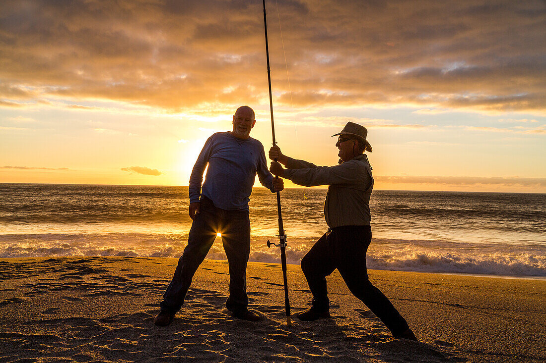 fishermen on beach, sunset, west coast, Hokitika, South Island, New Zealand