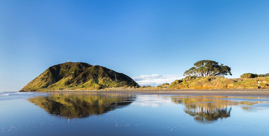 Reflection of the coast in water, East Cape, Gisborne, North Island, New Zealand, Oceania