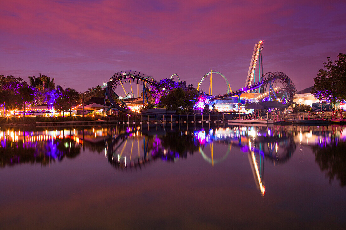 Reflection of Mako hypercoaster ride attraction at Sea World Orlando theme park at dusk, Orlando, Florida, USA