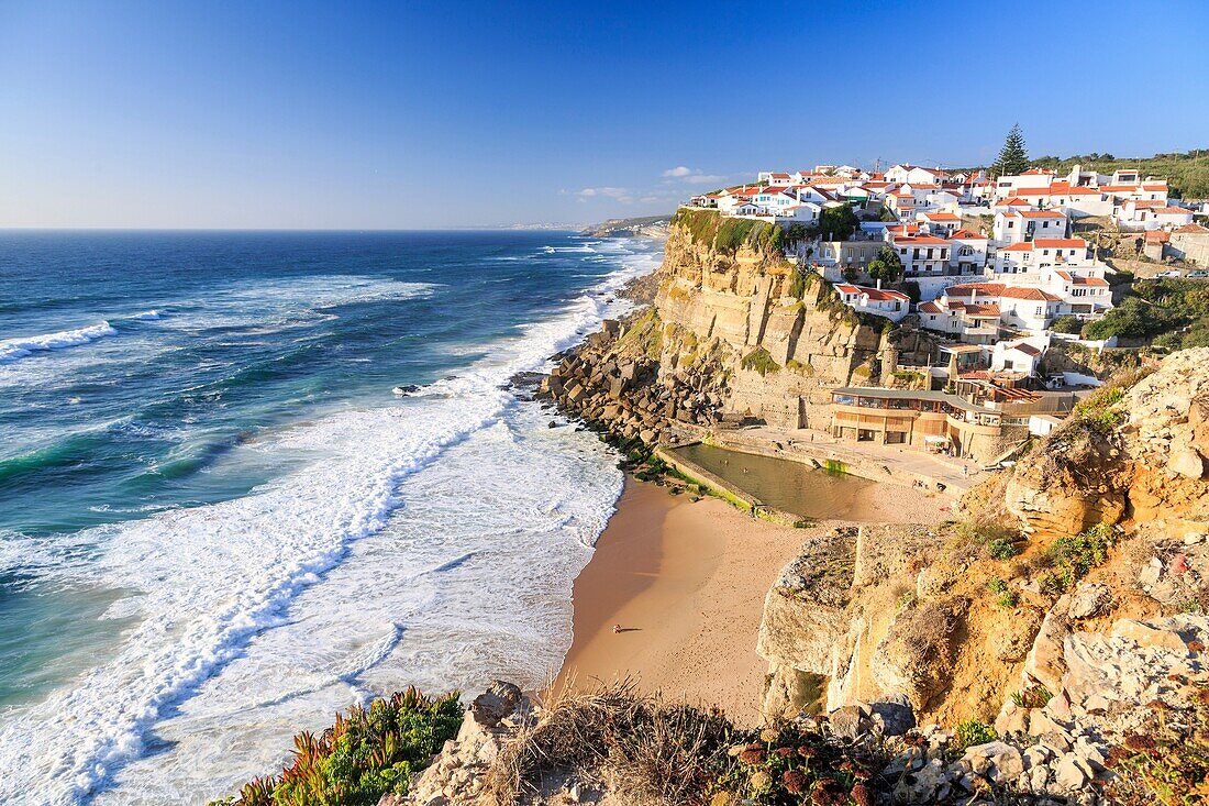 Top view of ocean waves crashing on the high cliffs of Azenhas do Mar Sintra Portugal Europe.