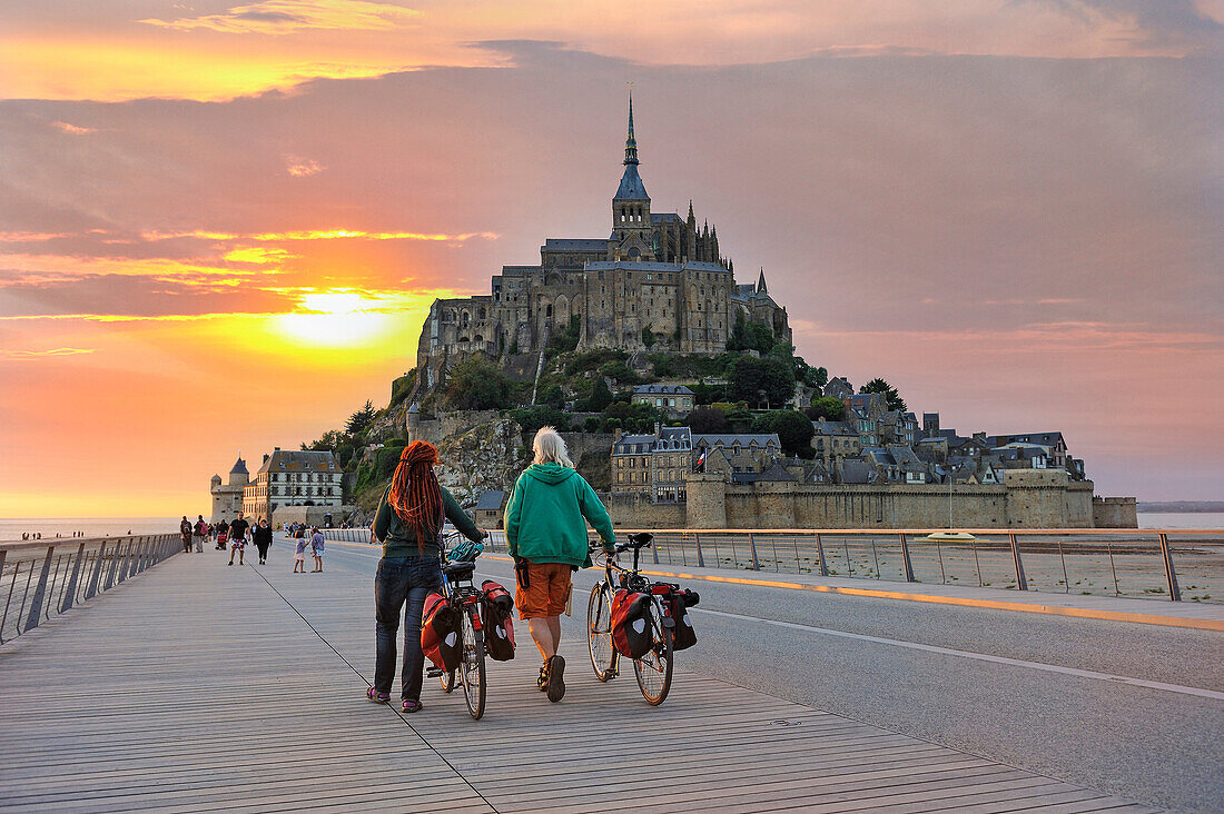 Touristen auf der Brücke, die zum Mont-Saint-Michel führt, Departement Manche, Region Normandie, Frankreich, Europa.