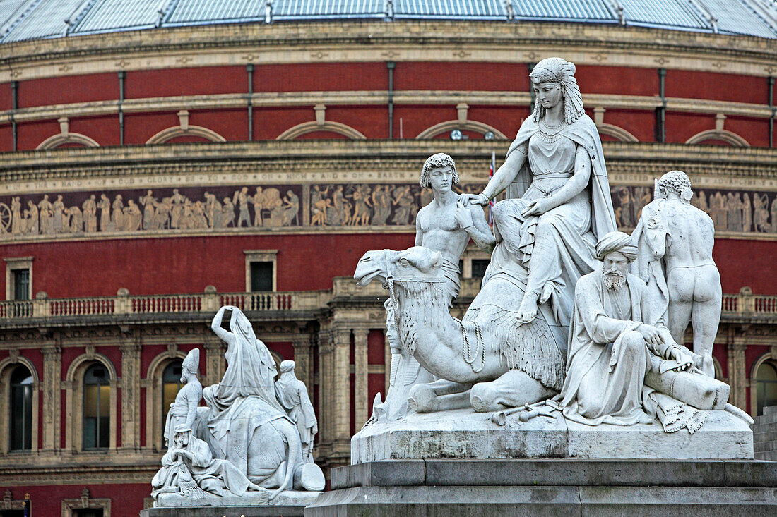 Groups of figures of Albert memorial and facade of Royal Albert Hall, Belgravia, London, Great Britain