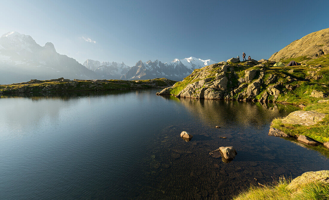 Hikers at Lac de Cheserys, Aiguilles Verte, Grandes Jorasses, Mont Blanc, Haute-Savoie, France