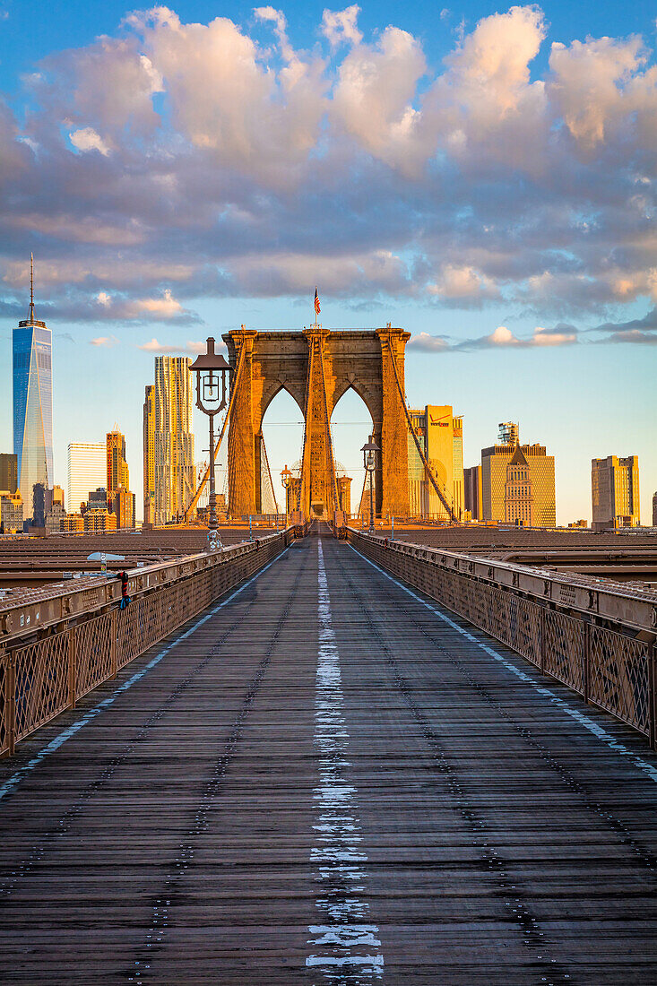 The Brooklyn Bridge is one of the oldest suspension bridges in the United States. Completed in 1883, it connects the New York City boroughs of Manhattan and Brooklyn by spanning the East River. With a main span of 1,595. 5 feet (486. 3 m), it was the long