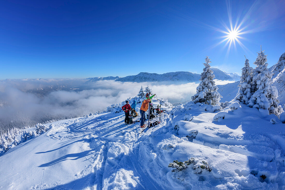 Several persons backcountry skiing having a break, Scheinbergspitze, Ammergau Alps, Upper Bavaria, Bavaria, Germany