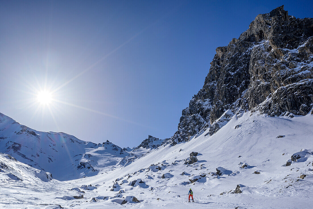 Woman backcountry skiing ascending towards Geier, Lizumer Reckner in background, Geier, Tuxer Alps, Tyrol, Austria