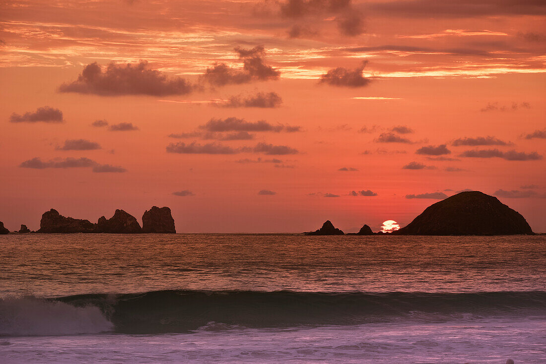 'The end to another day in paradise with a wonderful sunset behind the islands at Ixtapa; Ixtapa, Mexico'