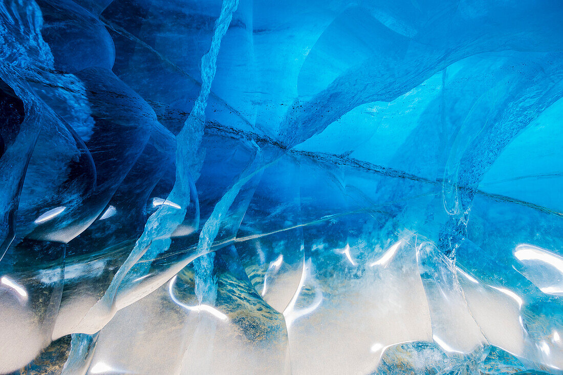 'Sunlight reflects off of and penetrates through the ice of Black Rapids Glacier; Alaska, United States of America'