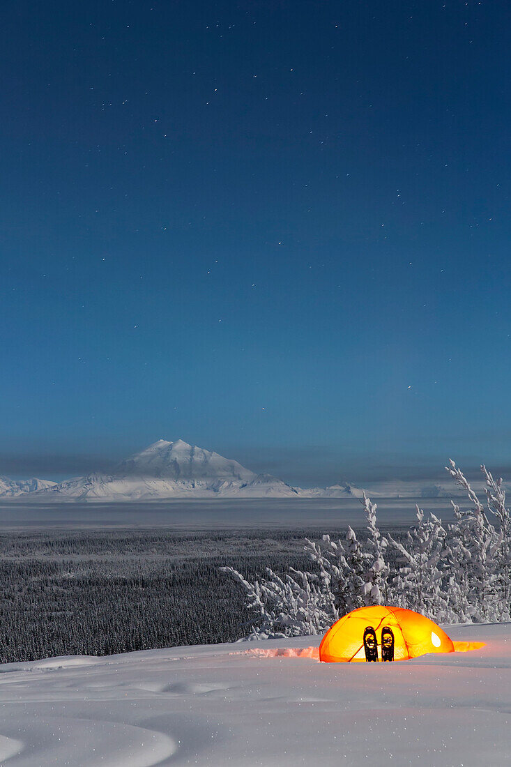 View of Mount Drum and the Copper River Valley with a tent and snowshoes in the foreground, Southcentral Alaska, USA, Winter