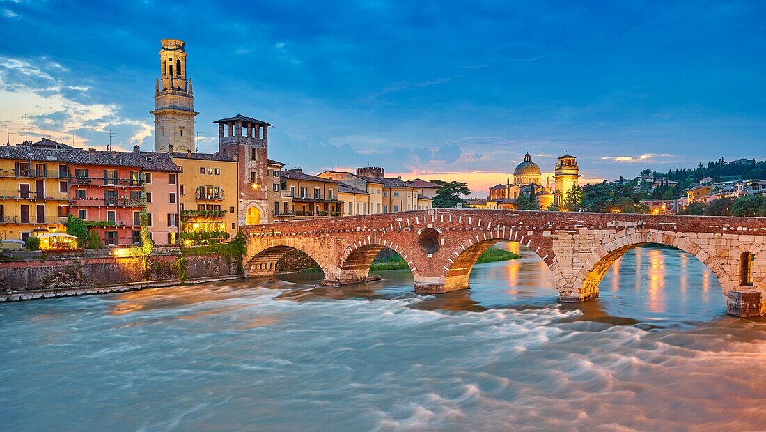 Ponte Pietra Bridge at evening dusk, Verona old town, Veneto region, Italy.