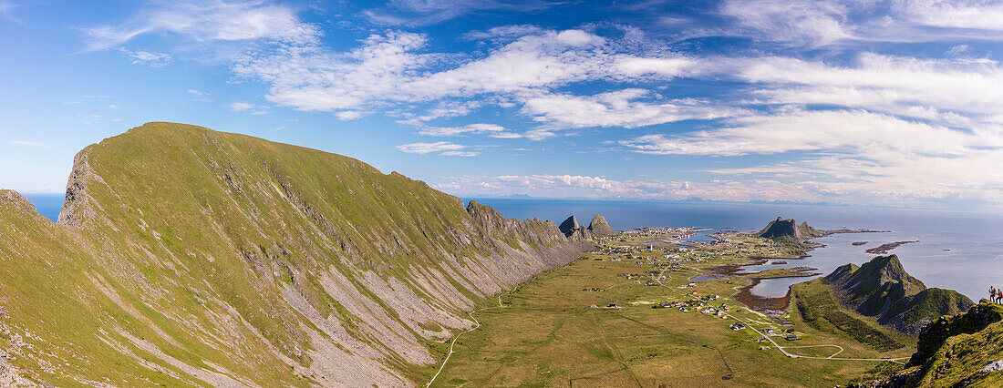 Mountain ridge frames the village of Sorland surrounded by sea, Vaeroy Island, Nordland county, Lofoten archipelago, Norway, Scandinavia, Europe