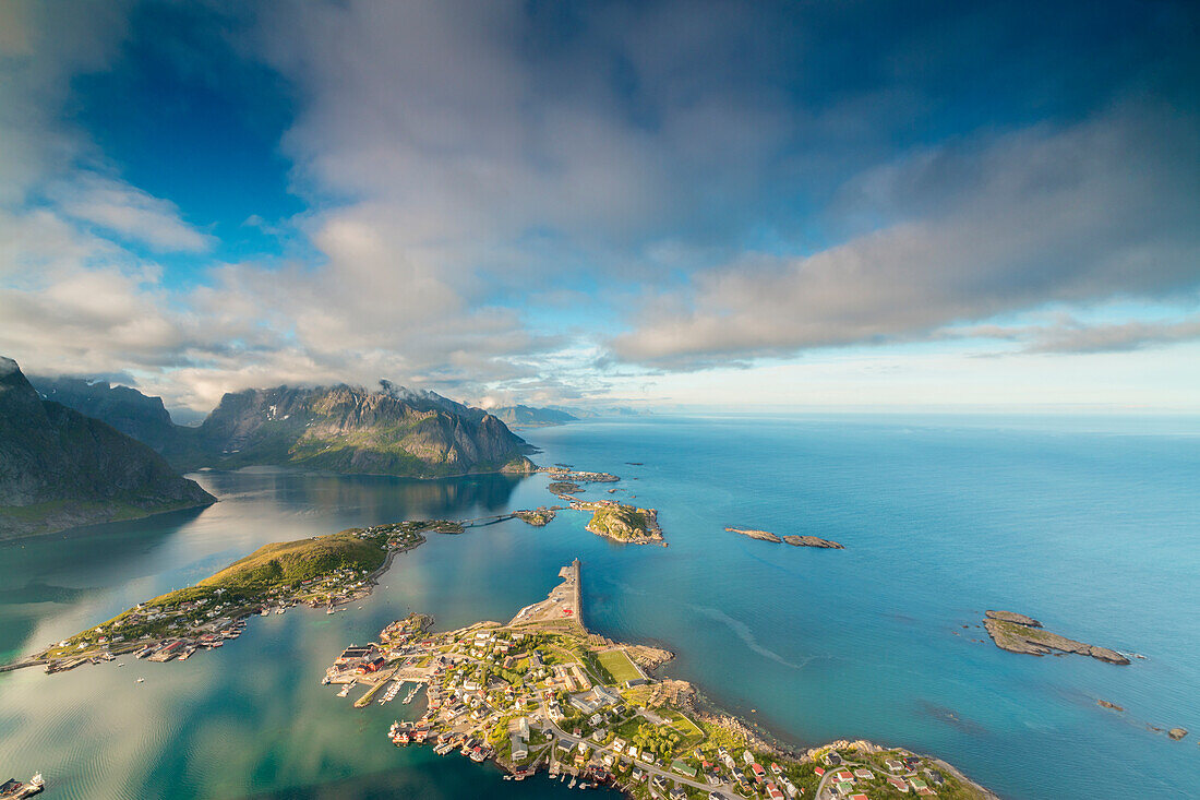 Blue sky and clouds frame the turquoise sea and the typical village, Reinebringen, Moskenesoya, Lofoten Islands, Norway, Scandinavia, Europe