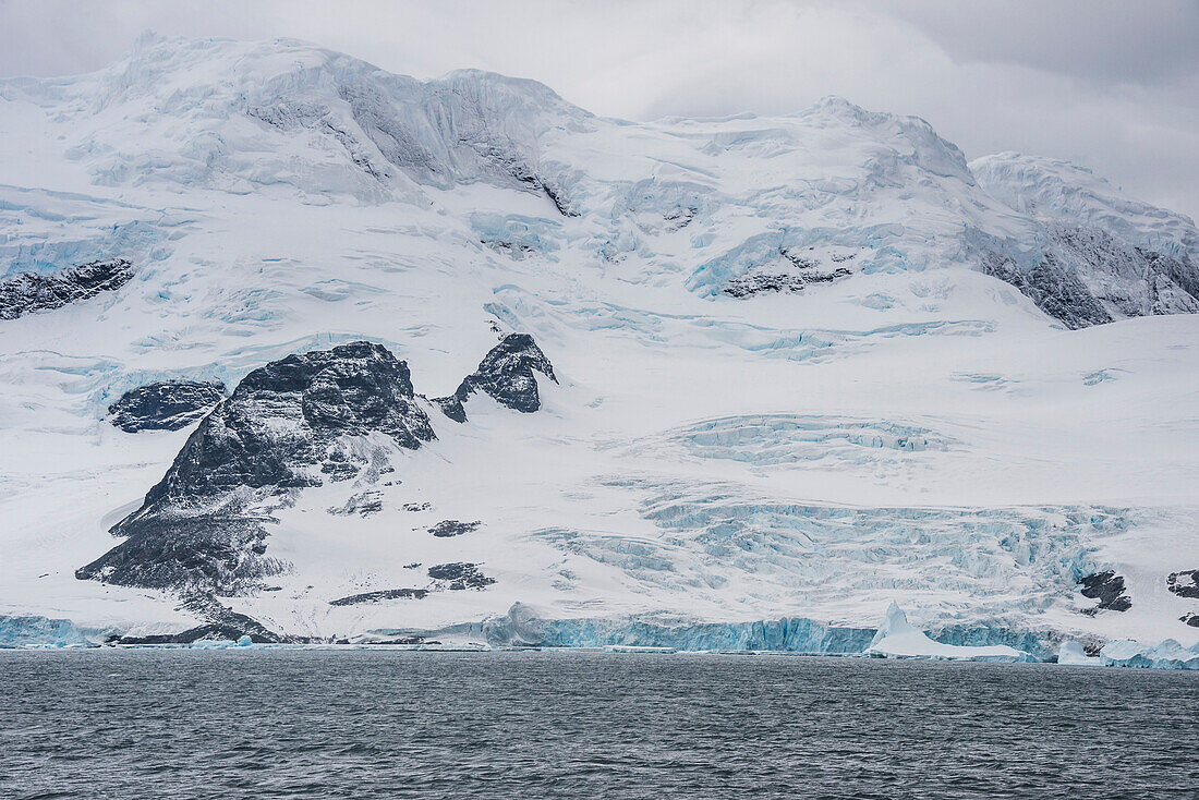 Glacier hanging on the rocks of Coronation Island, South Orkney Islands, Antarctica, Polar Regions