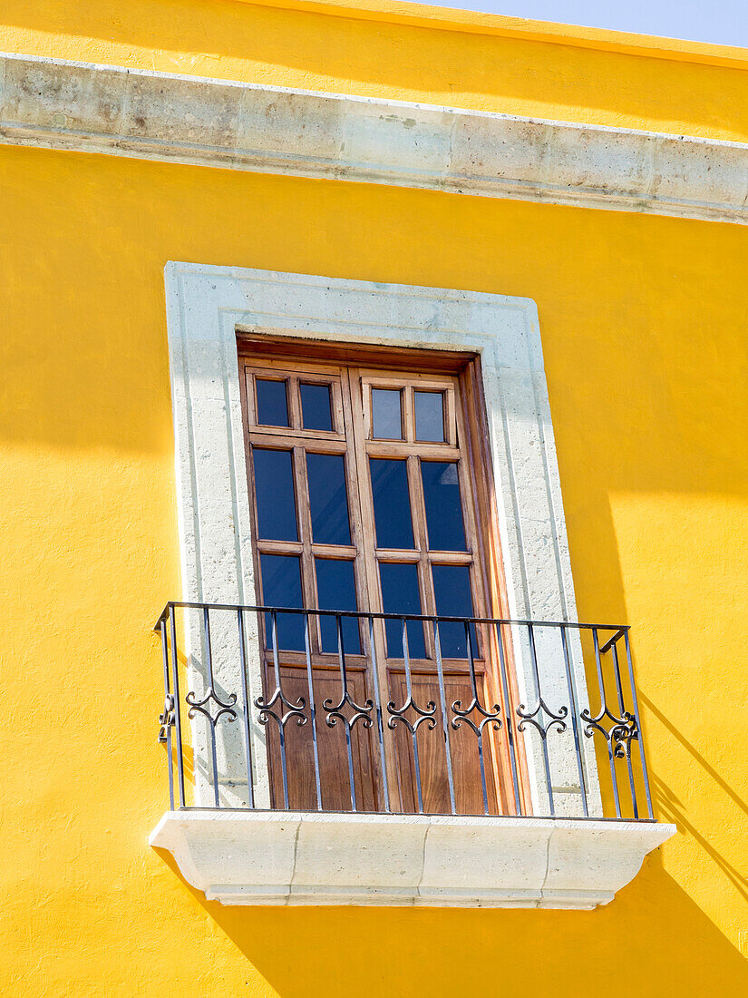 White window of yellow house, Oaxaca, Mexico, North America