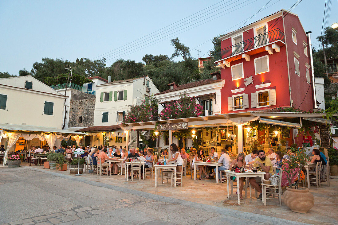 Harbourside restaurants in evening, Loggos, Paxos, Ionian Islands, Greek Islands, Greece, Europe