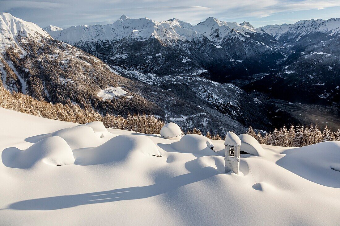 Italy, Italian Alps, Lombardy, The huts and the bell tower of Alpe Cima sorrounded by metres of snow