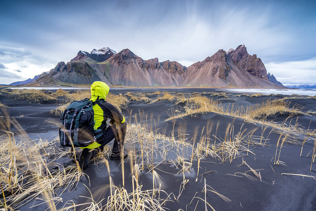 Man overlooking the landscape at Stokksnes, Eastern Iceland, Europe