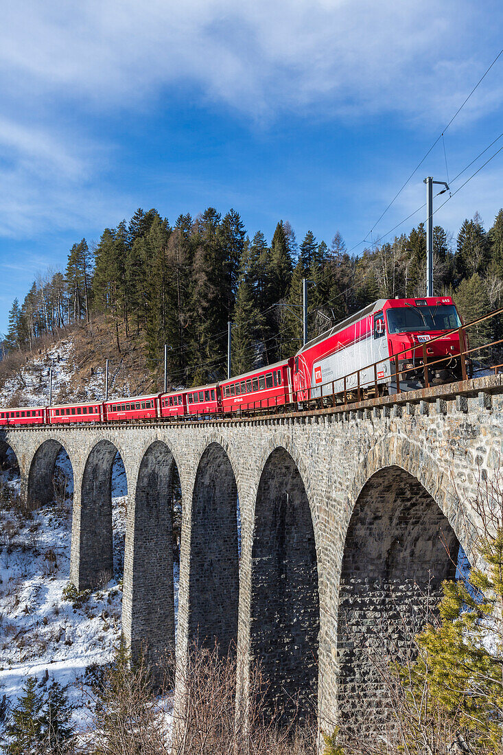 Bernina Express red train along Schmittentobel Viaduct, Filisur, Graubunden, Switzerland, Europe