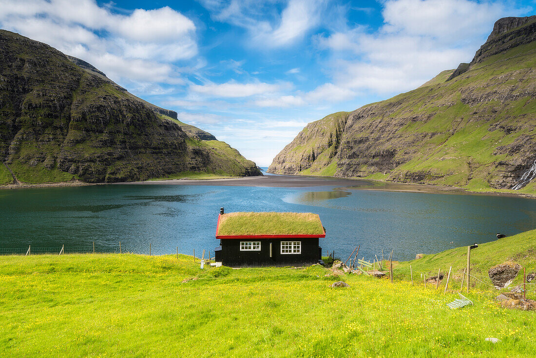 Saksun, Stremnoy island, Faroe Islands, Denmark, Iconic house with grass roof in front of the fiord