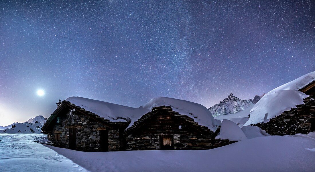 The Milky Way and the full moon lighting the huts at the Alpe Prabello, Prabello Alp, Valmalenco, Valtellina, Italy