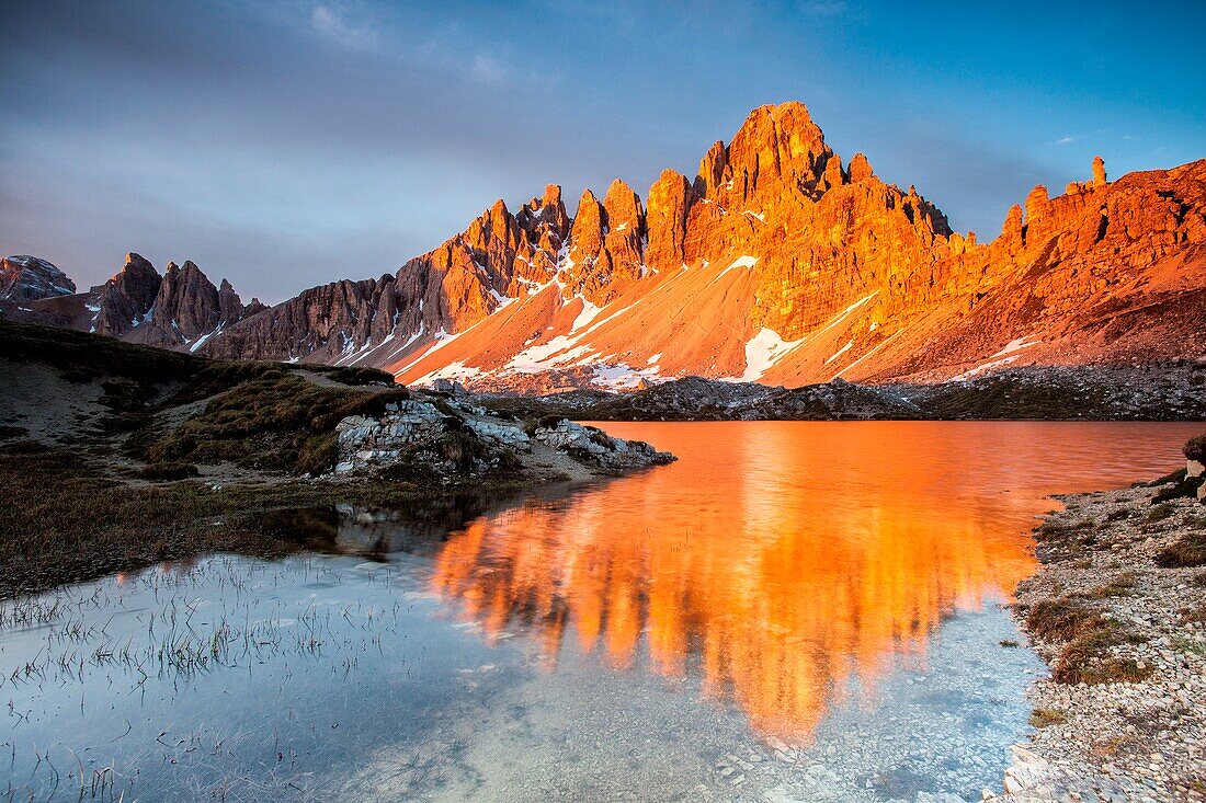 Dawn on the calcareous peaks of Mount Paterno reflected in the still water of Lakes of Piani, Locatelli refuge, Sesto of pusteria, Trentino Alto, Adige, Italy, Europe
