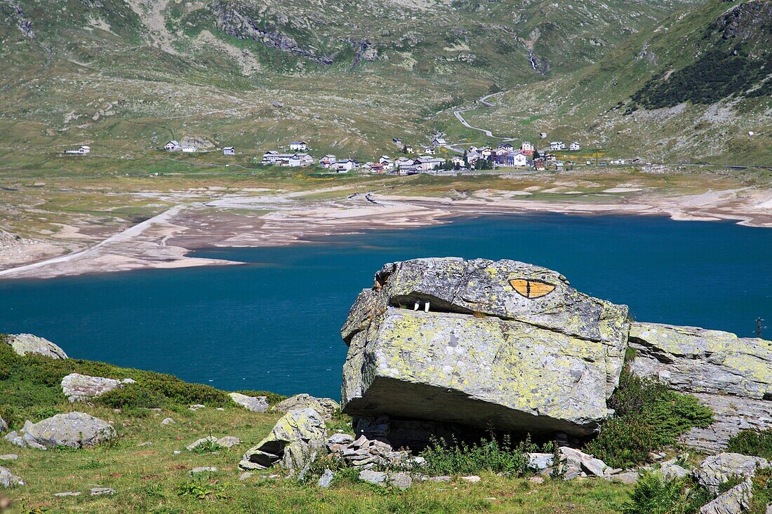 Rettile di roccia near Andossi, with view of the lake and the village of Montespluga, Andossi, Montespluga, Vallespluga, Valchiavenna, Lombardy, Italy