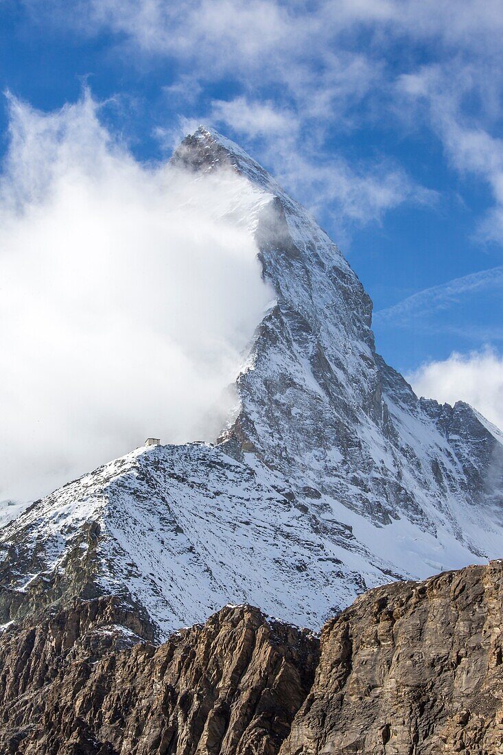 The peak of the Matterhorn covered in fog from the track to Hornli, hutte, Zermatt, Valais, Switzerland Europe