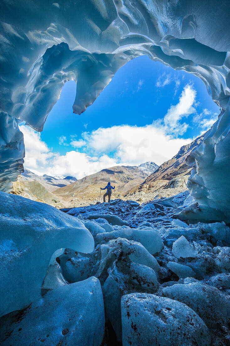 Hiker inside Forni Glacier Forni Valley Stelvio National Park Valfurva Valtellina Lombardy Italy Europe