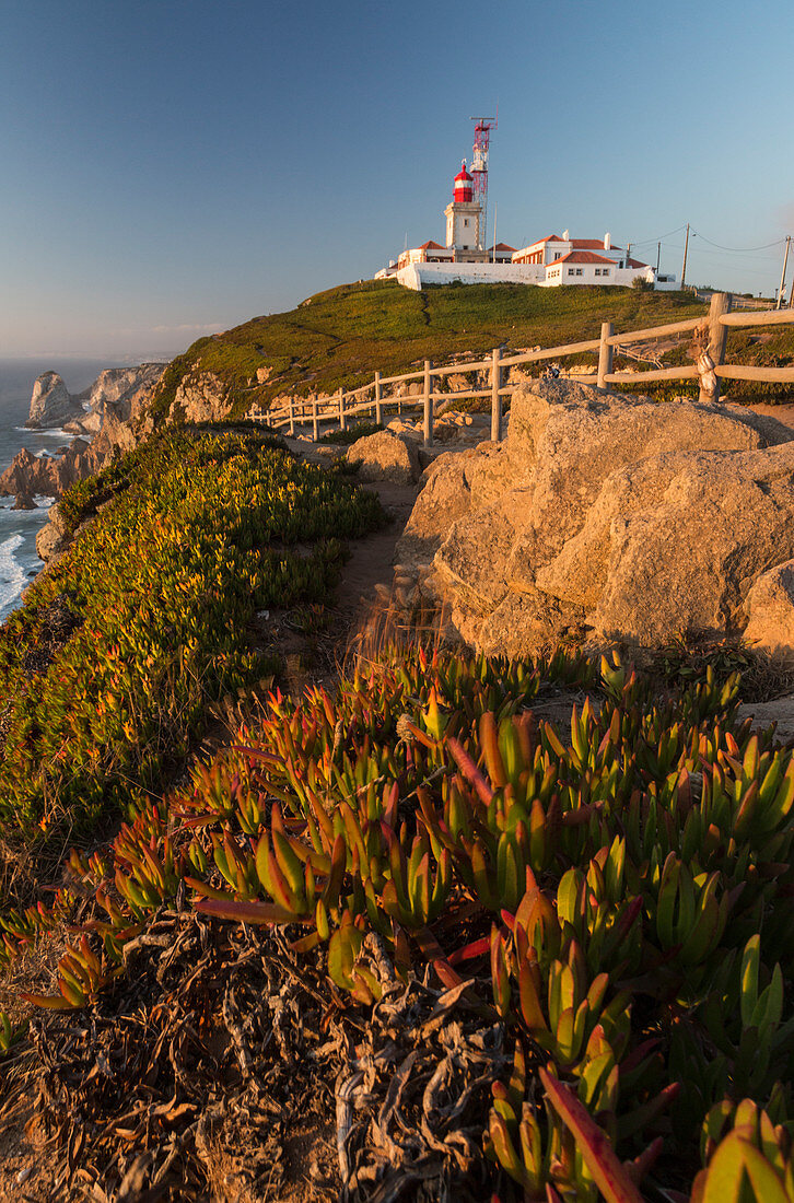 The Cabo da Roca lighthouse overlooks the promontory towards the Atlantic Ocean at sunset Sintra Portugal Europe