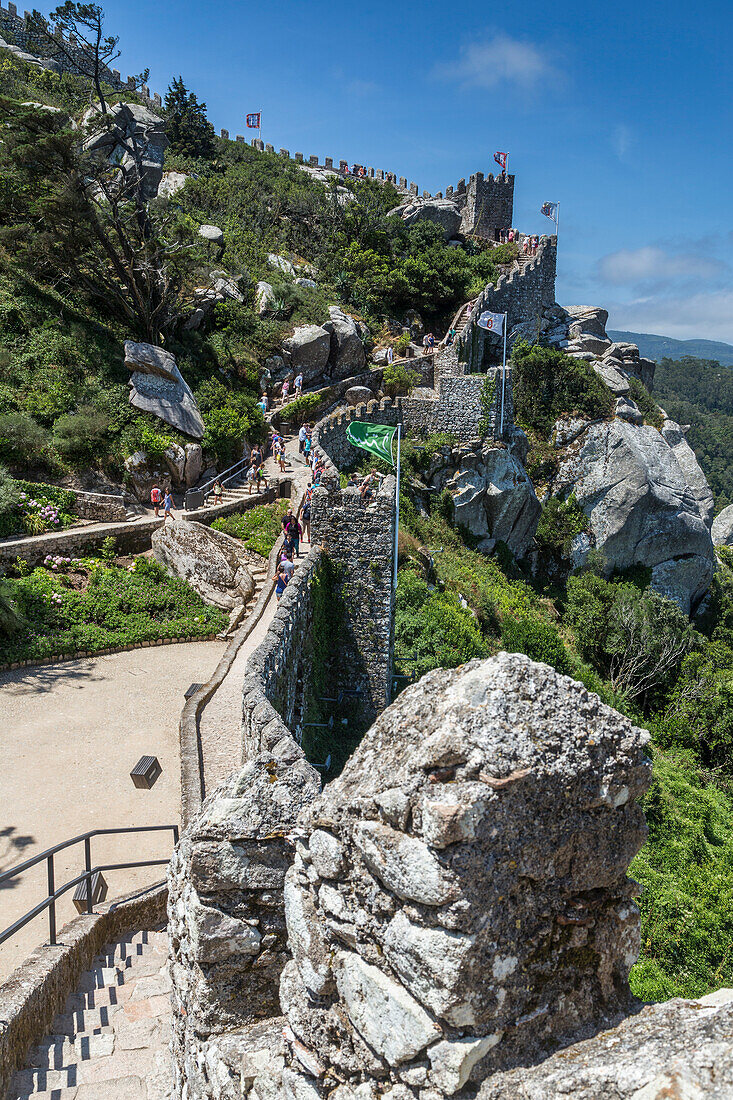 Tourists proceed towards the fortified stone tower of Castelo dos Mouros Sintra municipality Lisbon district Portugal Europe