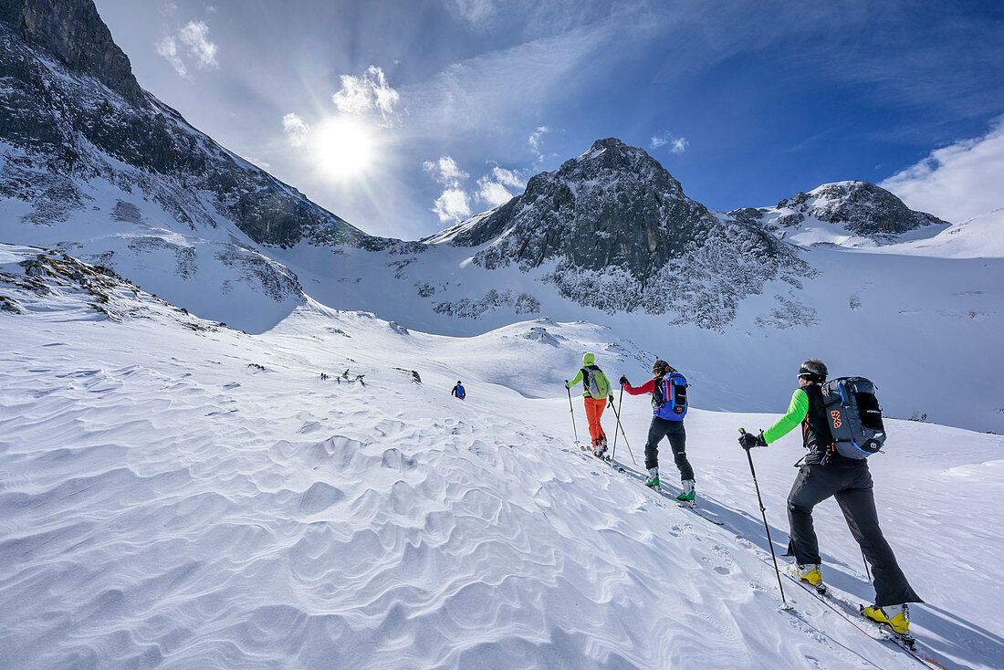 Four persons backcountry skiing ascending towards Fritzerkogel, Fritzerkogel, Tennengebirge range, Salzburg, Austria