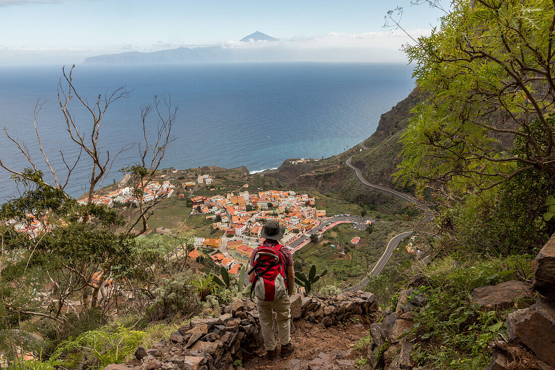 below is village Agulo, on horizon is Mount Teide, volcano, Spain's highest mountain, seen from La Gomera, Canary Islands, Spain