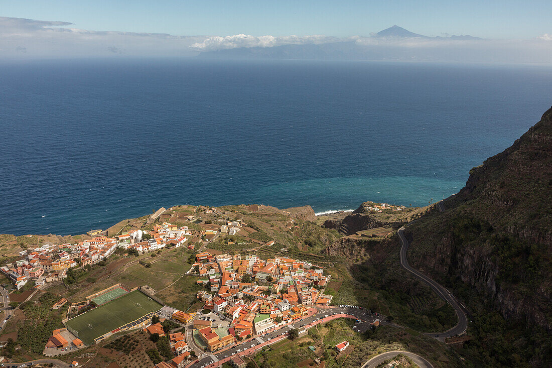 below is village Agulo, on horizon is Mount Teide, volcano, Spain's highest mountain, seen from La Gomera, Canary Islands, Spain